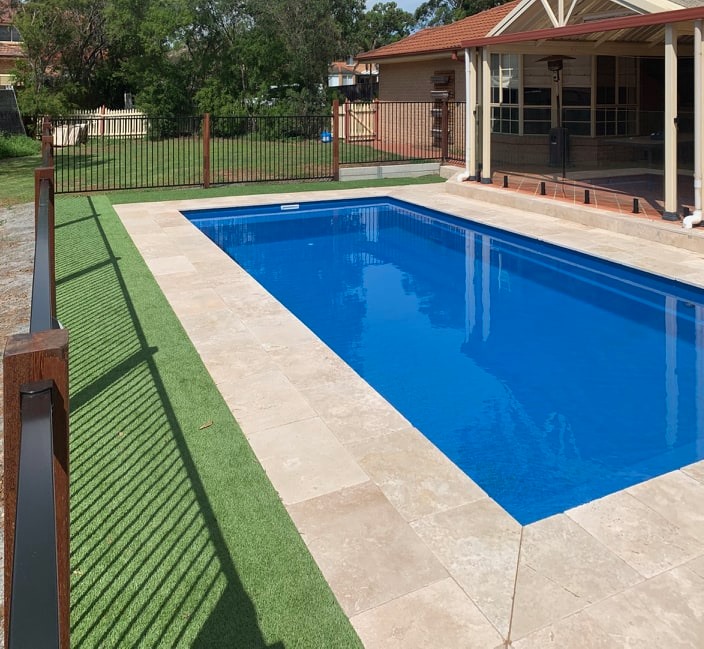 A finished family fibreglass pool in Bora Bora finish with full surrounds